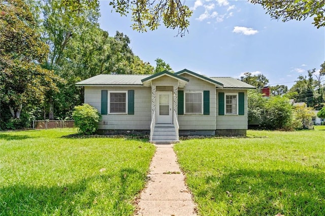 bungalow featuring crawl space, metal roof, and a front yard