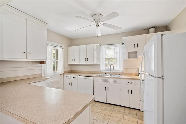 kitchen with white appliances, a healthy amount of sunlight, a sink, and open shelves