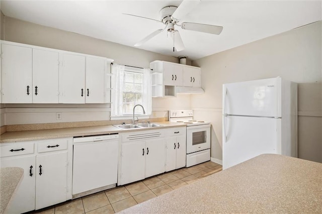 kitchen featuring white appliances, white cabinets, light countertops, a sink, and light tile patterned flooring