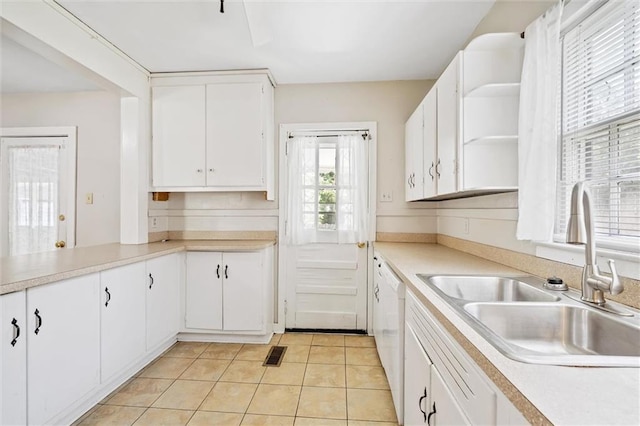 kitchen with light tile patterned floors, a sink, visible vents, light countertops, and open shelves