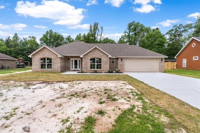 ranch-style house with a garage and a front yard