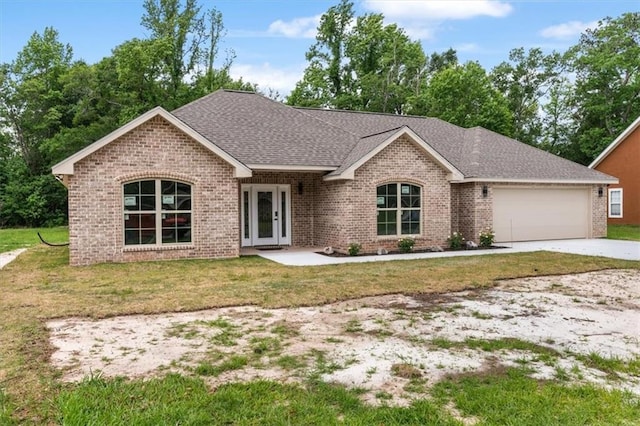 single story home featuring a garage, french doors, and a front yard