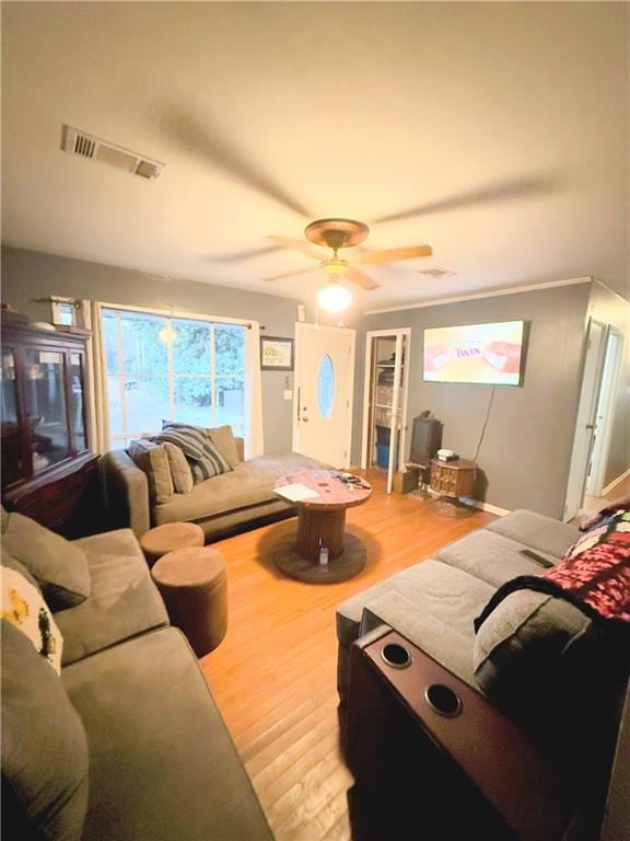 living room featuring ceiling fan and hardwood / wood-style floors