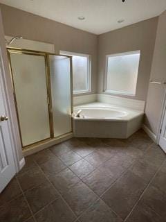 full bath with a stall shower and a garden tub