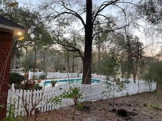 view of swimming pool featuring a fenced in pool and fence