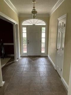 foyer entrance featuring baseboards and ornamental molding