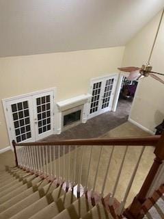 stairway with baseboards, lofted ceiling, and wood finished floors