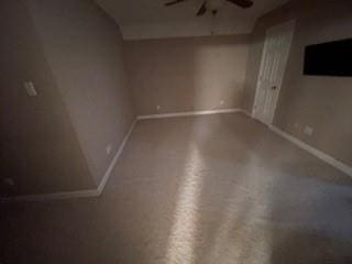 interior space featuring baseboards and a ceiling fan