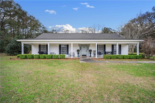 single story home featuring covered porch, a shingled roof, and a front yard