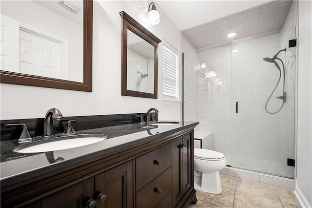 full bath with visible vents, a stall shower, and a sink