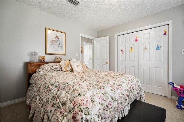 bedroom with a closet, visible vents, light colored carpet, and a textured ceiling