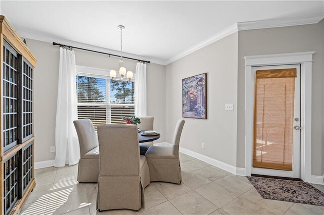 dining space featuring ornamental molding, a notable chandelier, baseboards, and light tile patterned floors