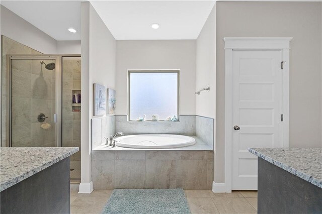 full bathroom featuring a stall shower, a garden tub, and tile patterned floors