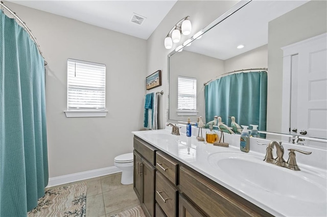 full bath with toilet, plenty of natural light, and a sink