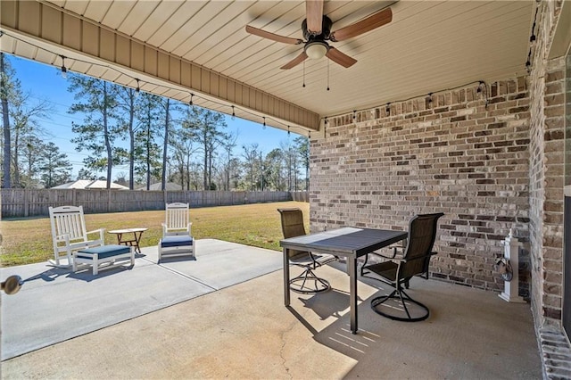 view of patio / terrace featuring a ceiling fan, outdoor dining area, and a fenced backyard