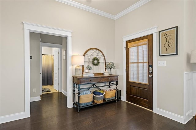 foyer entrance with ornamental molding, baseboards, and wood finished floors