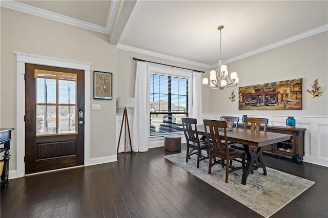 dining space with dark wood-style flooring, crown molding, and an inviting chandelier