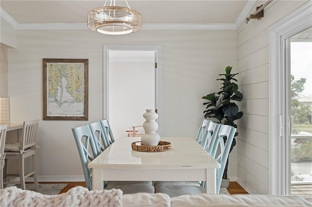 dining area featuring crown molding and wood finished floors