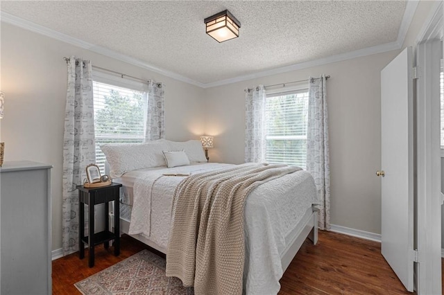 bedroom with multiple windows, dark wood-style floors, a textured ceiling, crown molding, and baseboards