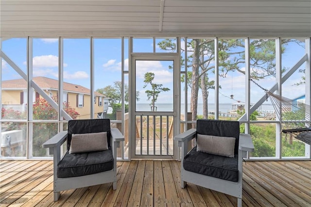 sunroom / solarium with a water view