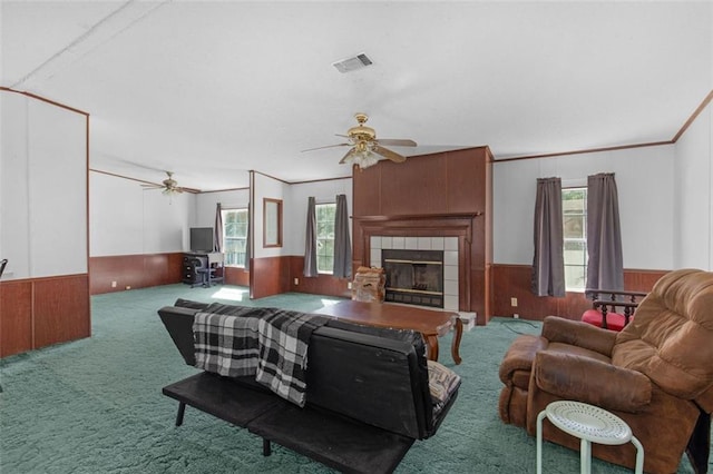 living room with carpet floors, wainscoting, and plenty of natural light