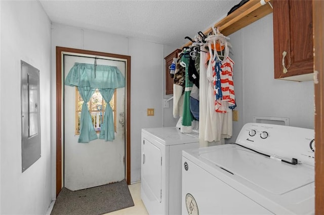 laundry room with cabinet space, washer and clothes dryer, and a textured ceiling