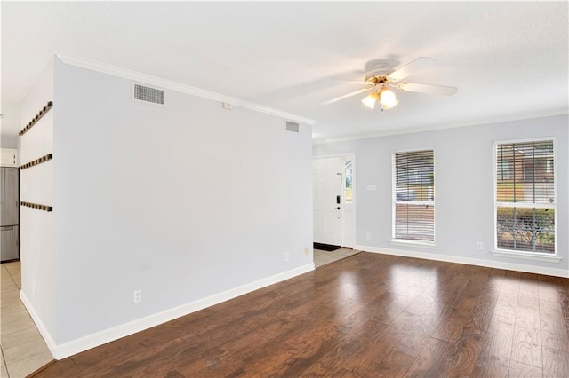 empty room with ornamental molding, ceiling fan, and light hardwood / wood-style floors