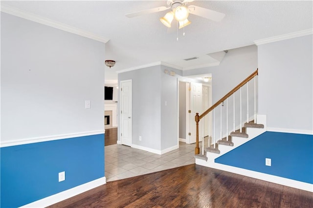 spare room featuring ornamental molding, hardwood / wood-style floors, and ceiling fan