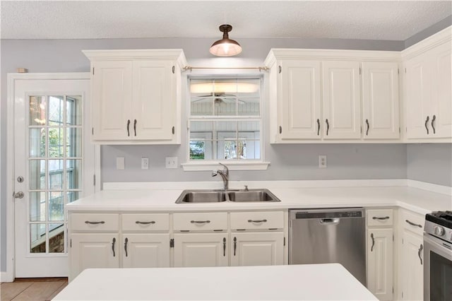 kitchen featuring white cabinetry, sink, a healthy amount of sunlight, and appliances with stainless steel finishes