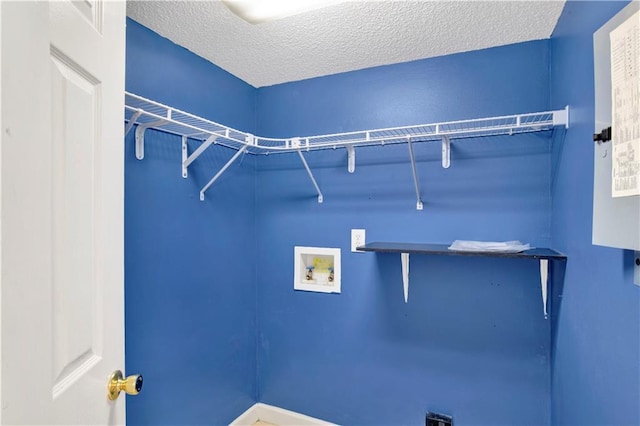 laundry area featuring hookup for a washing machine, a textured ceiling, and electric dryer hookup