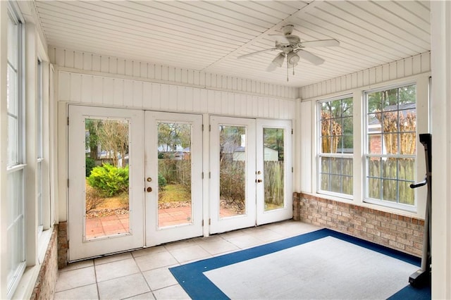 unfurnished sunroom featuring french doors and ceiling fan