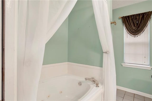 bathroom featuring tile patterned flooring, a tub, and a textured ceiling