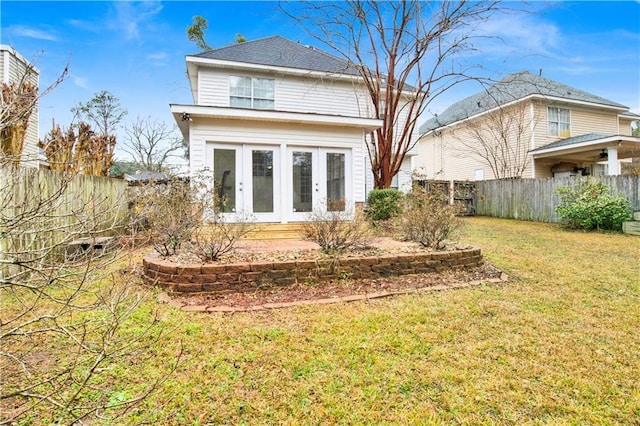 back of property featuring a yard and french doors