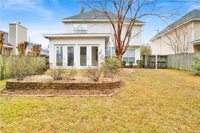 rear view of house featuring a yard