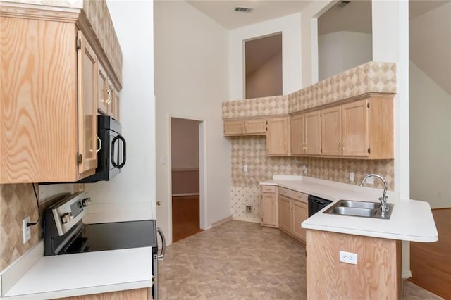 1056 Cross Gates Pl, Mobile, AL 36609 - kitchen featuring stainless steel range with electric cooktop, black microwave, a peninsula, decorative backsplash, and light countertops