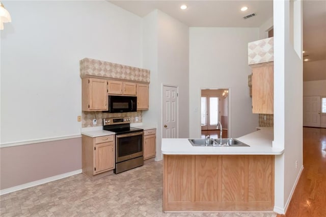 1056 Cross Gates Pl, Mobile, AL 36609 - kitchen with stainless steel electric range oven, black microwave, a towering ceiling, light countertops, and tasteful backsplash