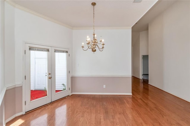 1056 Cross Gates Pl, Mobile, AL 36609 - empty room featuring wood finished floors, a chandelier, ornamental molding, and french doors