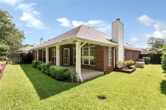 1056 Cross Gates Pl, Mobile, AL 36609 - back of house with a chimney, a patio, brick siding, and a shingled roof