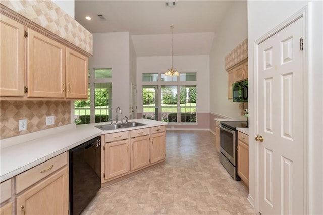 1056 Cross Gates Pl, Mobile, AL 36609 - kitchen with black appliances, light brown cabinets, a peninsula, a chandelier, and decorative backsplash