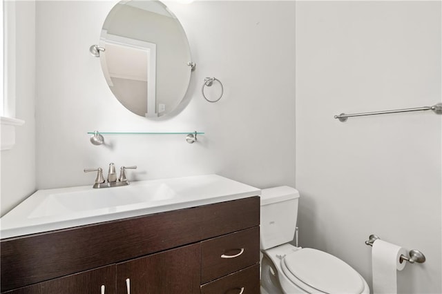 half bathroom featuring toilet and vanity