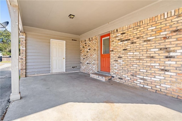 doorway to property featuring brick siding