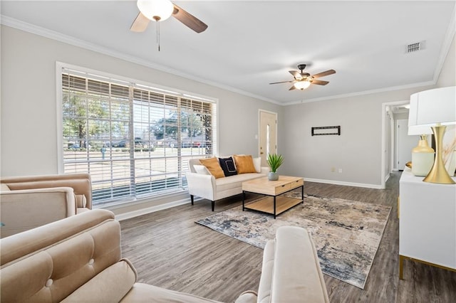 living area featuring visible vents, crown molding, and wood finished floors