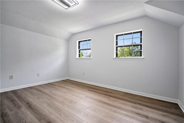 709 Oak Field Dr, Mobile, AL 36609 - bonus room featuring lofted ceiling, baseboards, and wood finished floors