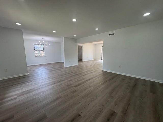 709 Oak Field Dr, Mobile, AL 36609 - unfurnished room with a chandelier, recessed lighting, dark wood-style flooring, and baseboards
