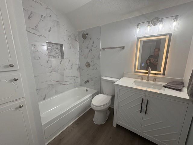 709 Oak Field Dr, Mobile, AL 36609 - bathroom with wood finished floors, toilet, vanity, shower / bath combination, and lofted ceiling