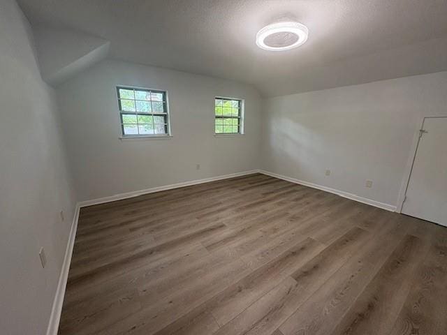 709 Oak Field Dr, Mobile, AL 36609 - additional living space featuring vaulted ceiling, baseboards, and wood finished floors