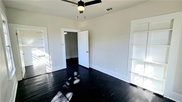 unfurnished bedroom with a closet, ceiling fan, and dark hardwood / wood-style floors