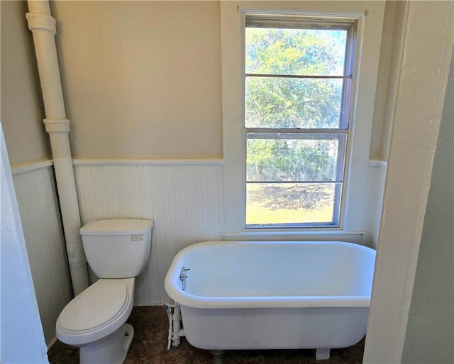 bathroom featuring toilet and a tub