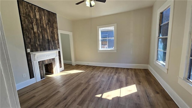 unfurnished living room featuring ceiling fan and hardwood / wood-style flooring