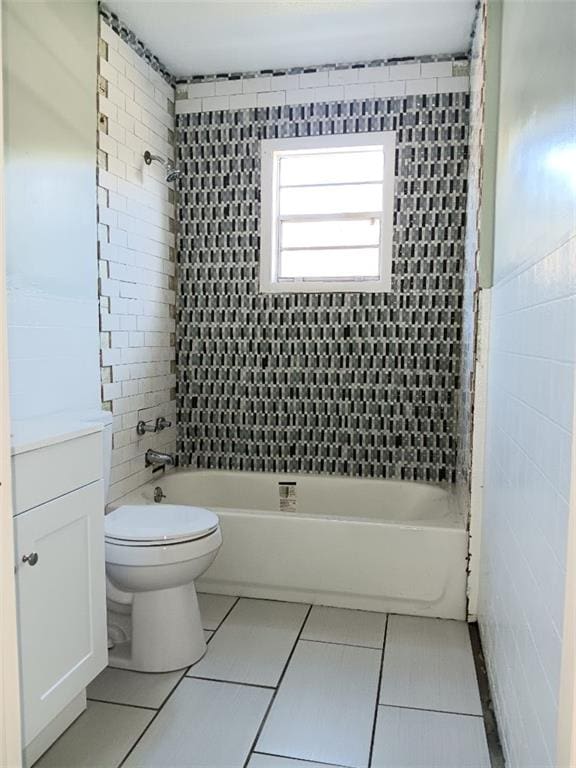 full bathroom with vanity, toilet, tile patterned floors, and tiled shower / bath